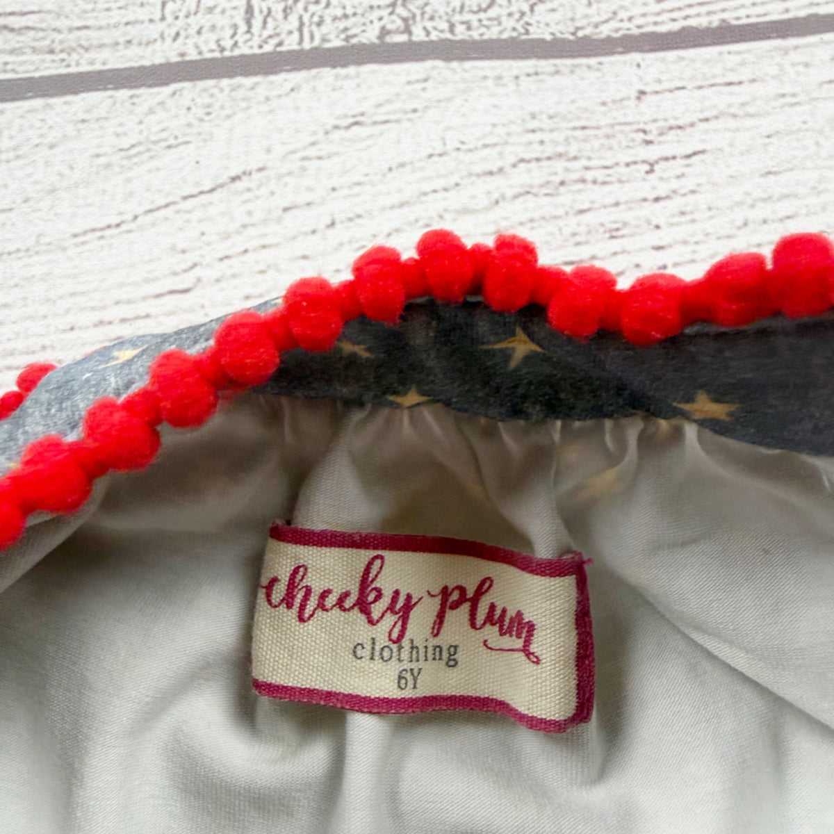 Cheeky Plum Star Print Sleeveless Girls Dress Red Pom Trim 6